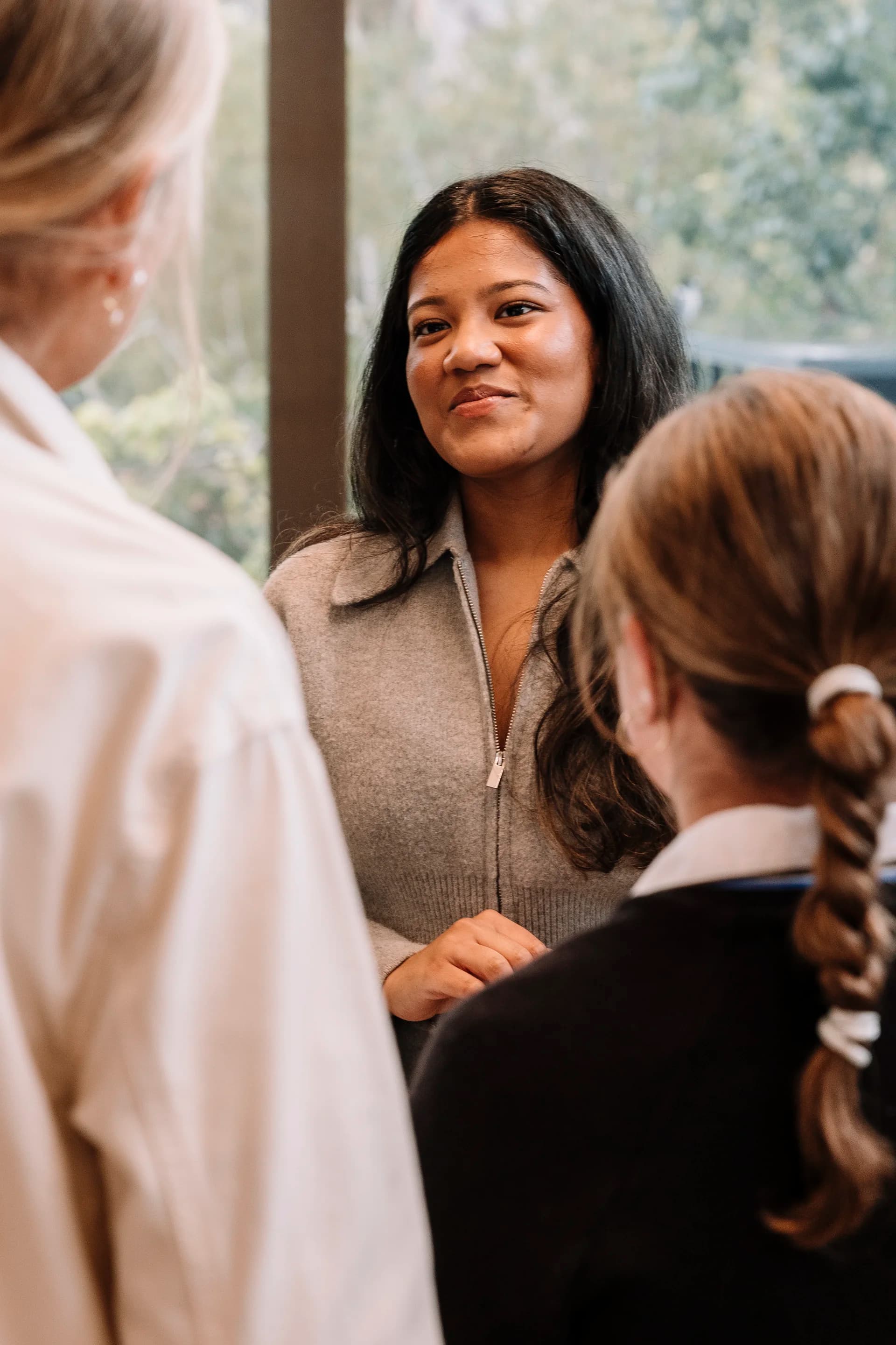 A TMJ tutor in conversation with a student, building trust