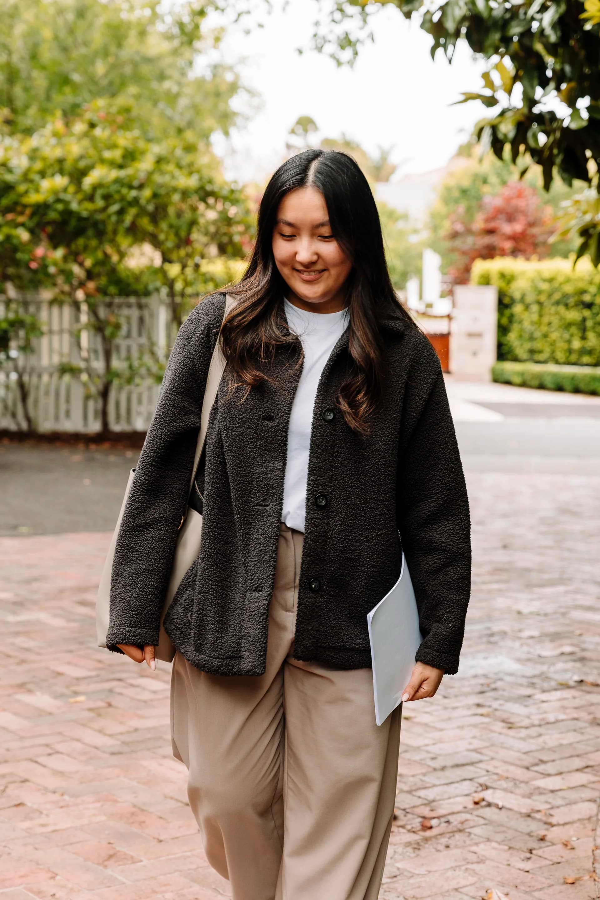 A tutor arriving at a student's home, smiling at the door