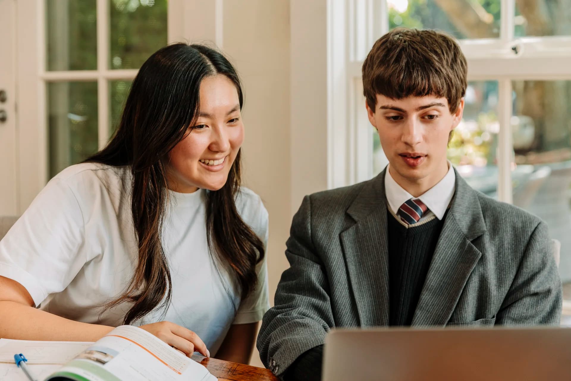A student working confidently on their own while the tutor observes